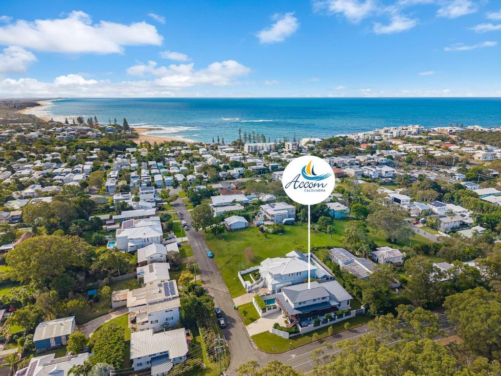 an aerial view of a city with a hotel sign and the ocean at 15 Derby Road Moffat Beach in Caloundra