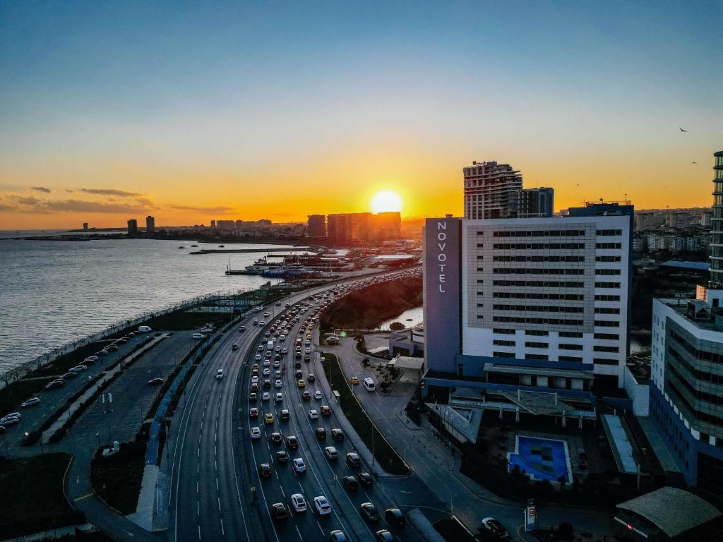 a sunset over a city with traffic on a freeway at Novotel Istanbul Zeytinburnu in Istanbul