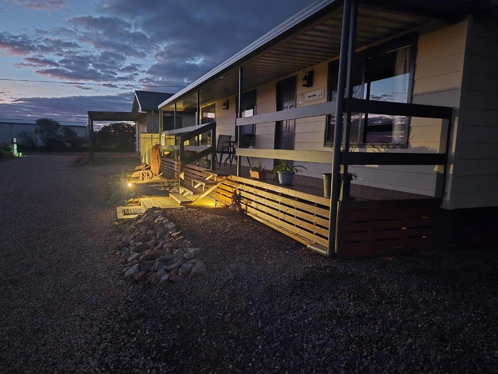 a house with a lit up porch and a building at Wudinna Farm View in Wudinna