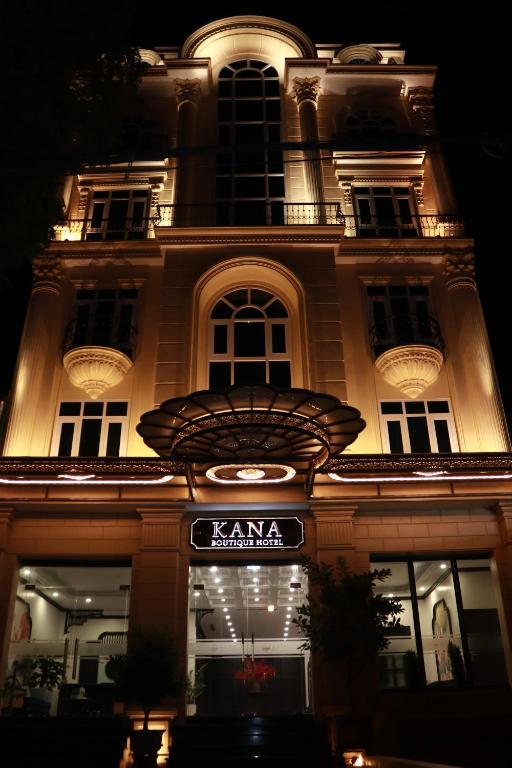a building with a sign in front of it at night at Kana Boutique Hotel Ninh Bình in Ða Gia