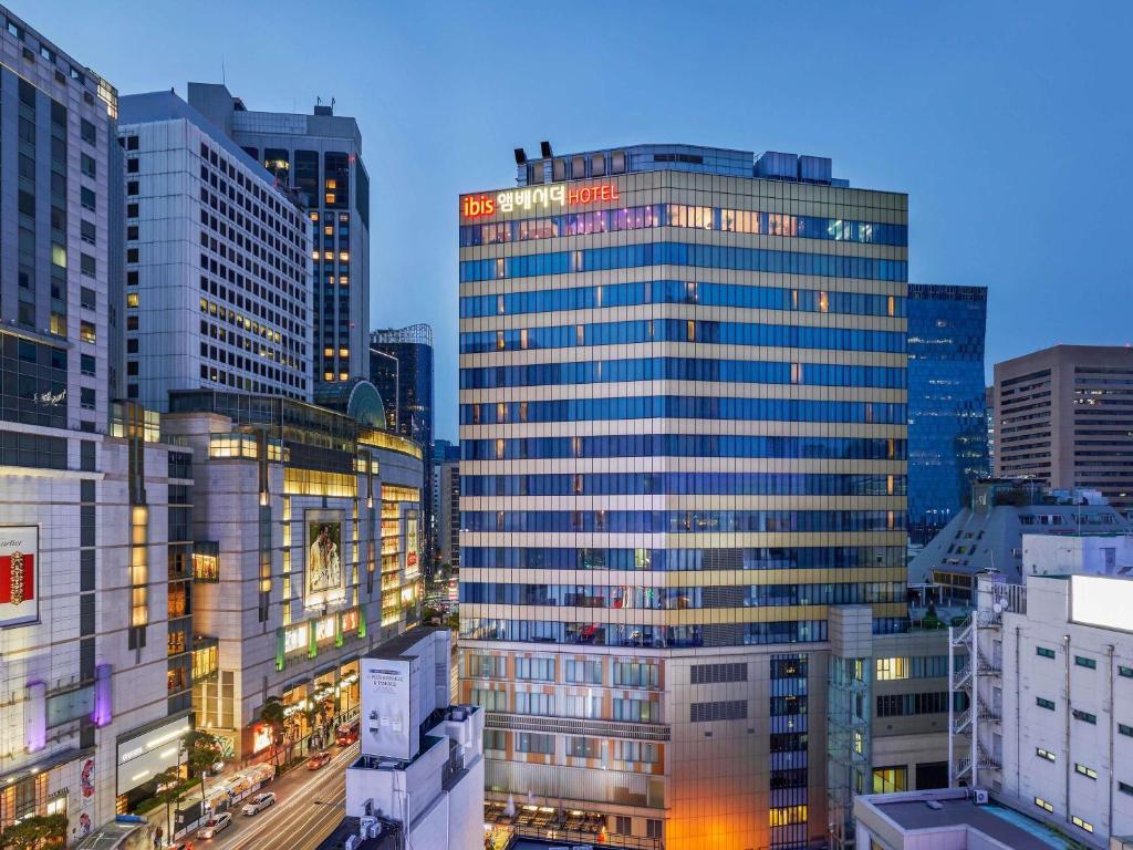 a group of tall buildings in a city at night at Ibis Ambassador Myeongdong in Seoul