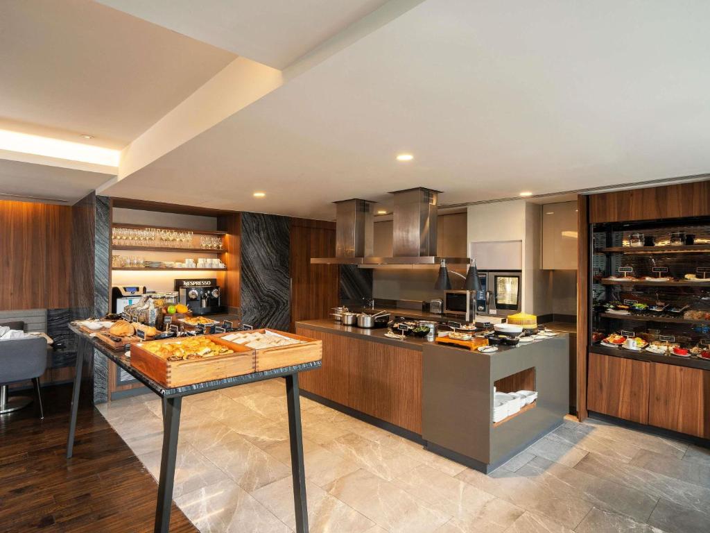 A polished buffet kitchen with a central food display.