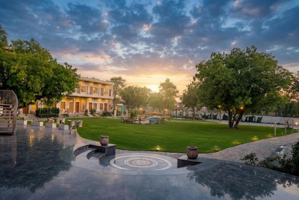 a view of a park with a building at Kadamb Kuteer Hotel and Resort in Chhatikara
