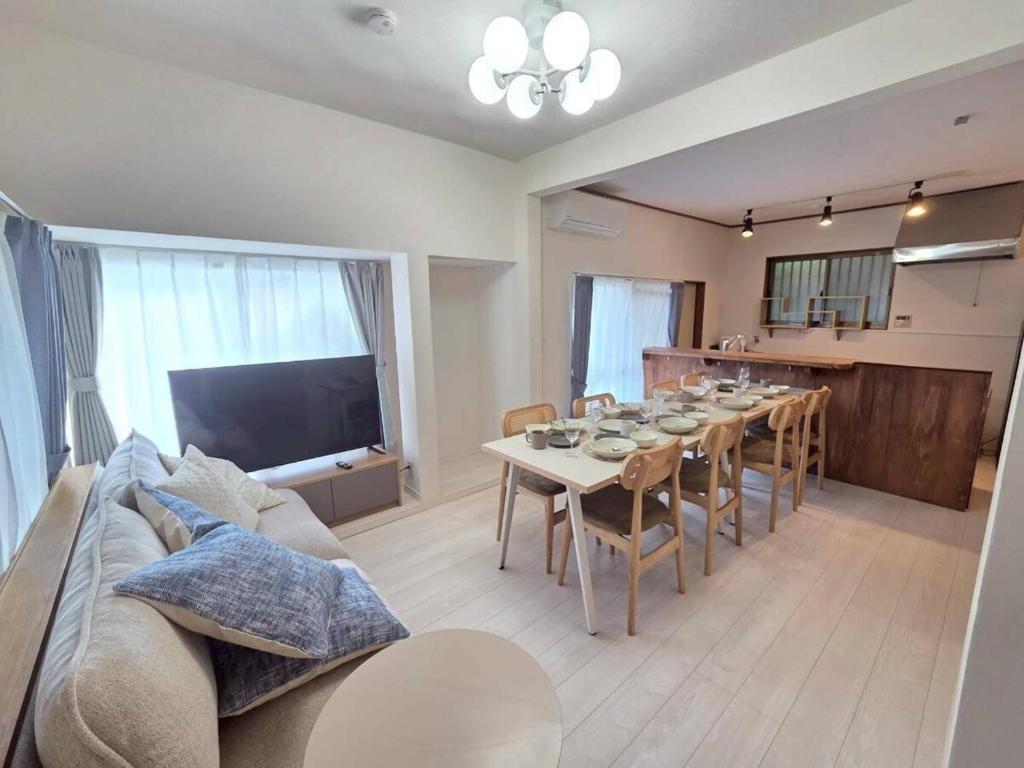 a living room with a long table and a couch at 横須賀-1軒家2棟 in Yokosuka