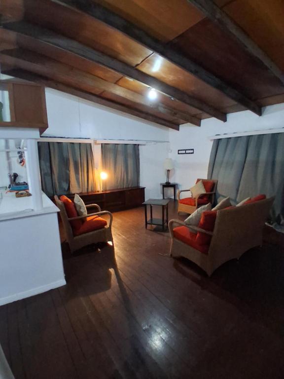 a living room with two couches and a table at Grace Homestay in Somosomo