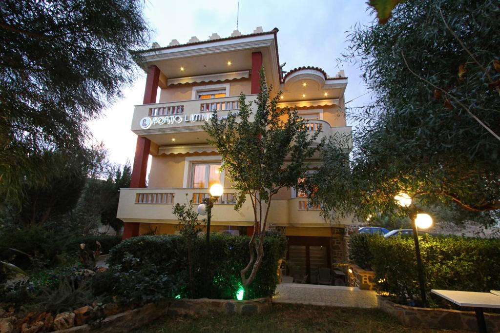 a building with a sign on the side of it at Porto Limnia in Volissos