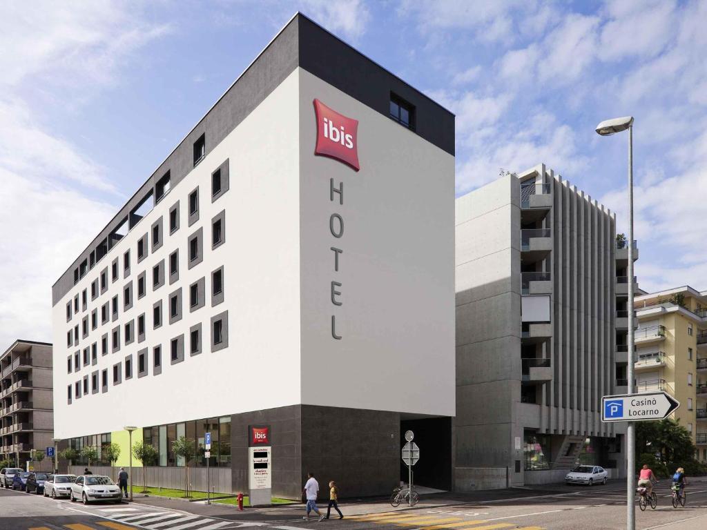 a large white building with a fedex sign on it at ibis Locarno in Locarno