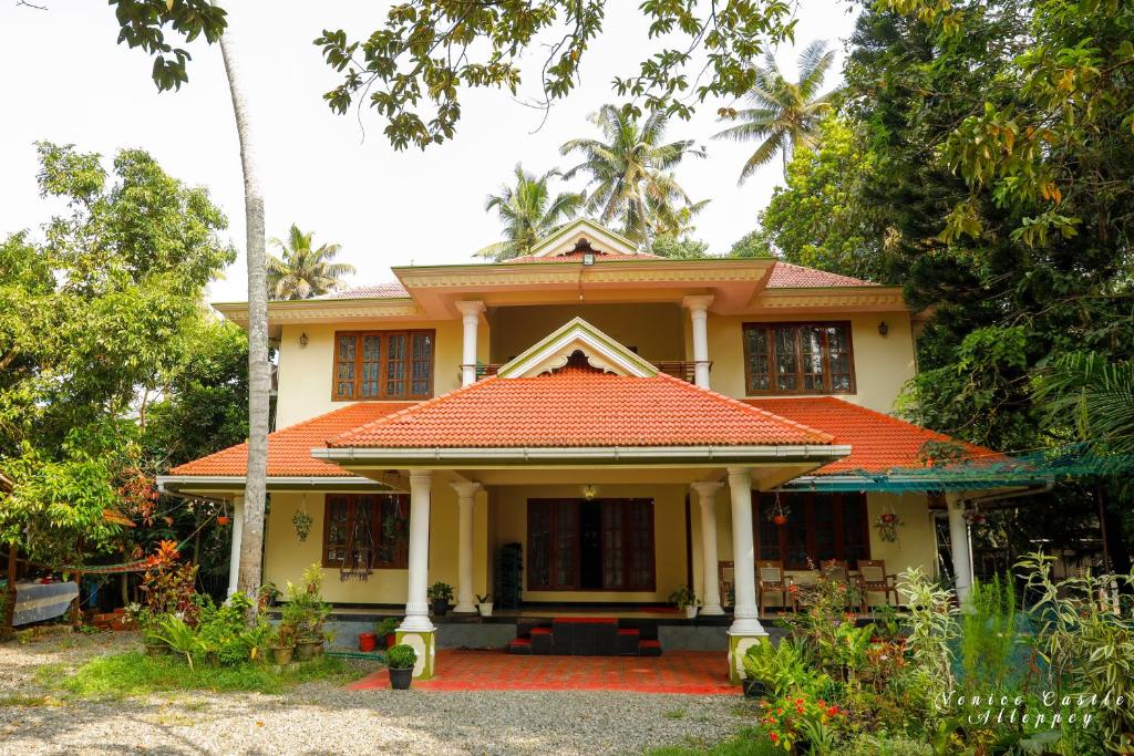 a house with an orange tile roof at Venice Castle in Alleppey