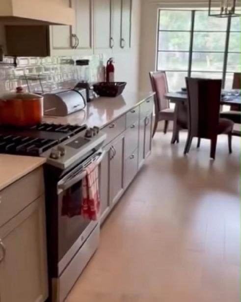 a kitchen with a stove and a table with chairs at Abundant Life in Arlington