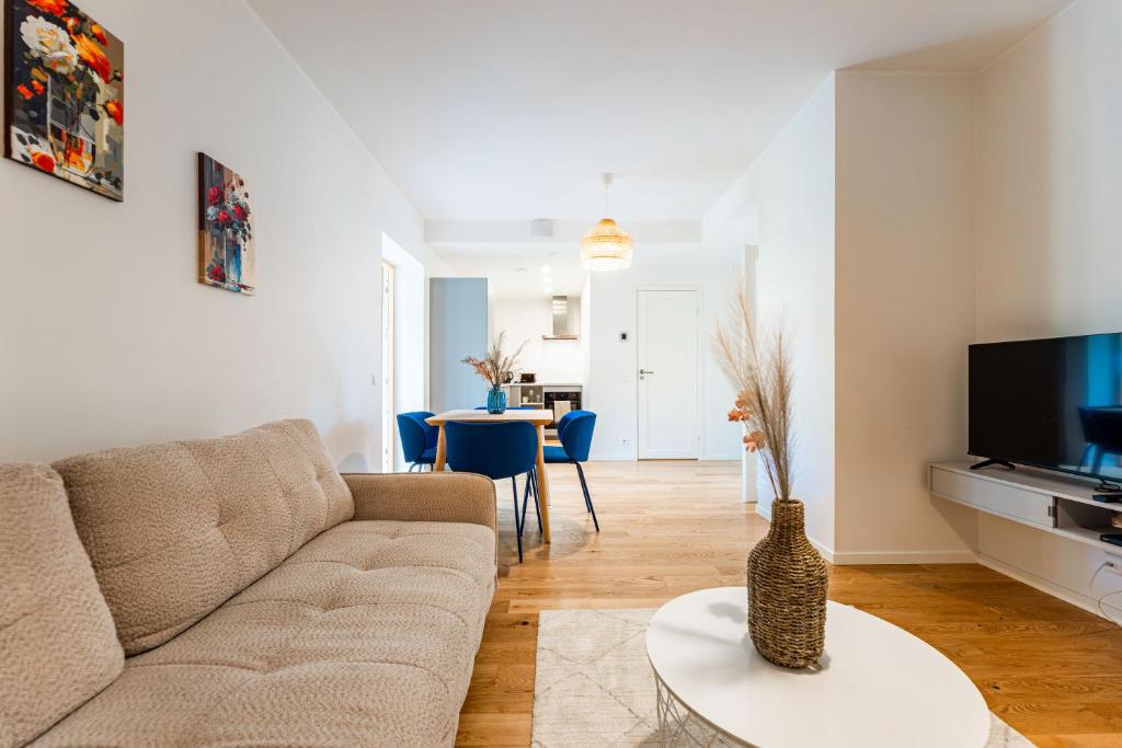 a living room with a couch and a table at Komandandi City Center Apartments in Kuressaare