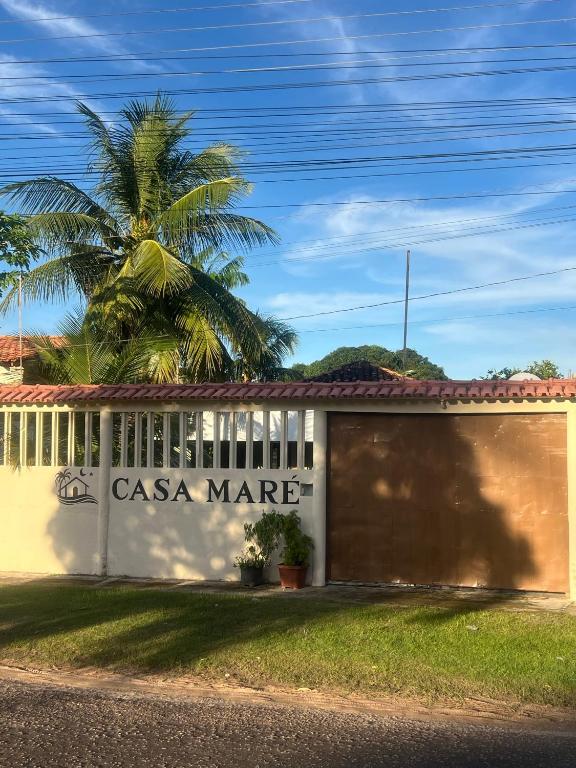 a casa marne building with a palm tree behind it at Casa Maré in Soure
