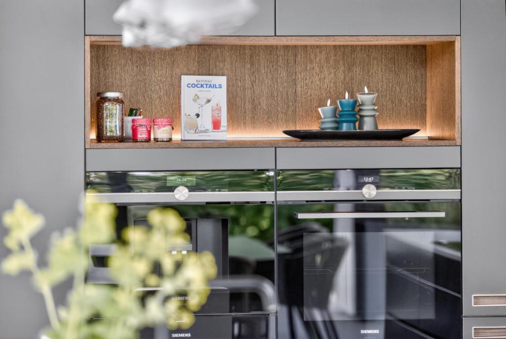 a shelf in a kitchen with a plate on it at Luxurious Holiday Home with Sauna & Outdoor Hot Tub in Hejls