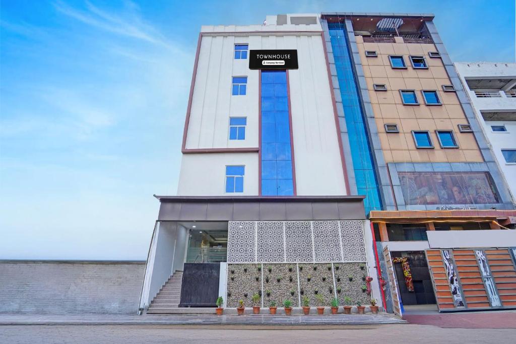 a tall building with a door in front of it at Townhouse Vikas Nagar Lucknow Formerly Wave BLU in Lucknow