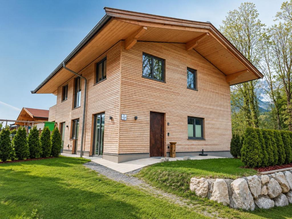 a wooden house with a gambrel roof at powderhome in Going am Wilden Kaiser