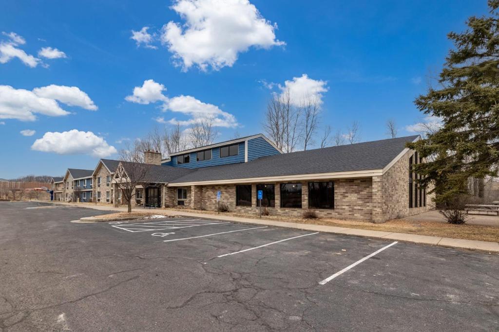 an empty parking lot in front of a building at AmericInn by Wyndham White Bear Lake St. Paul in White Bear Lake