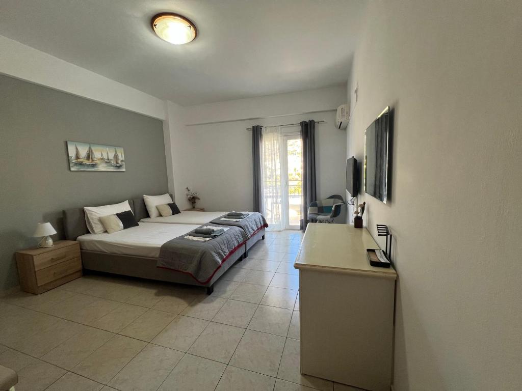 a bedroom with a bed and a desk in it at Heaven Studios & Apartments in Stalís
