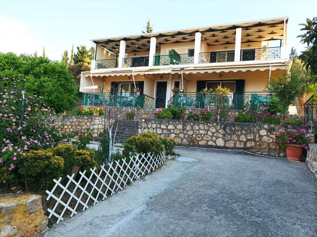 a house with a white fence in front of it at To Ampelaki in Tsoukalades