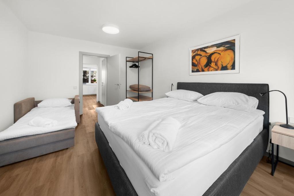 a bedroom with two beds with white sheets at K4 Jonava Rooms in Jonava