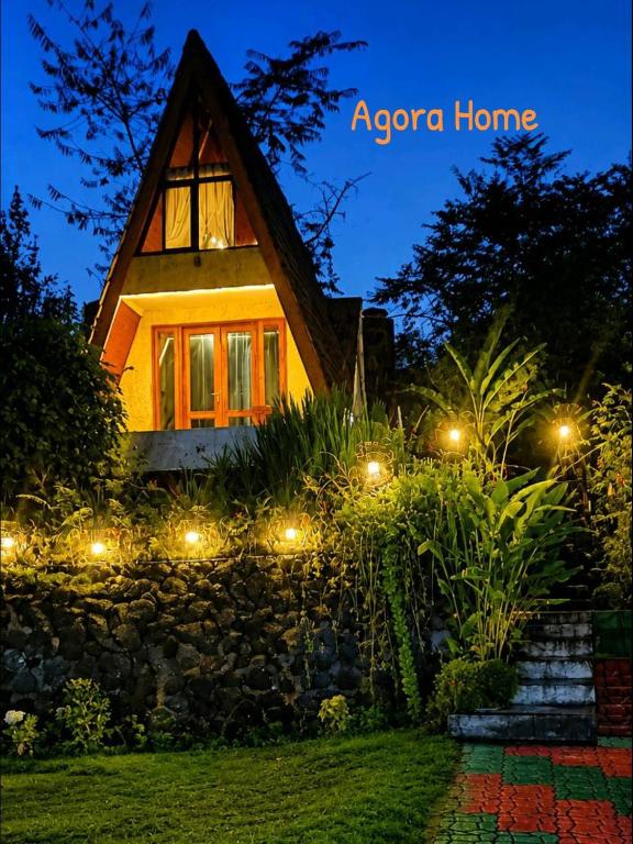 a house with lights in front of it at night at Agora Home in Wonosobo