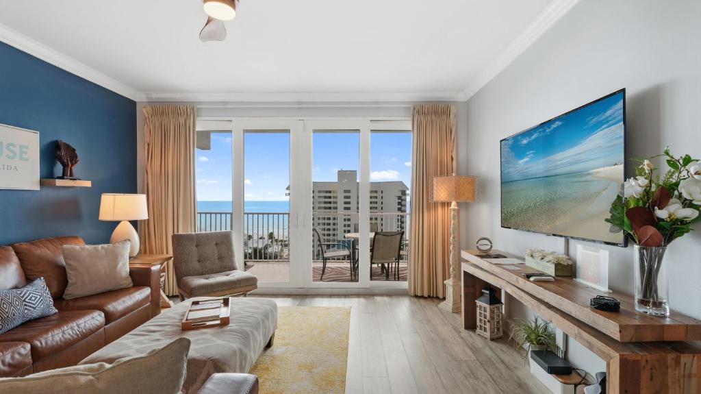 a living room with a couch and a large screen tv at Laketown Wharf 809 in Panama City Beach
