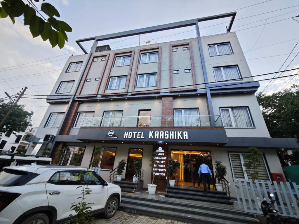 a white car parked in front of a building at Hotel Kaashika in Varanasi