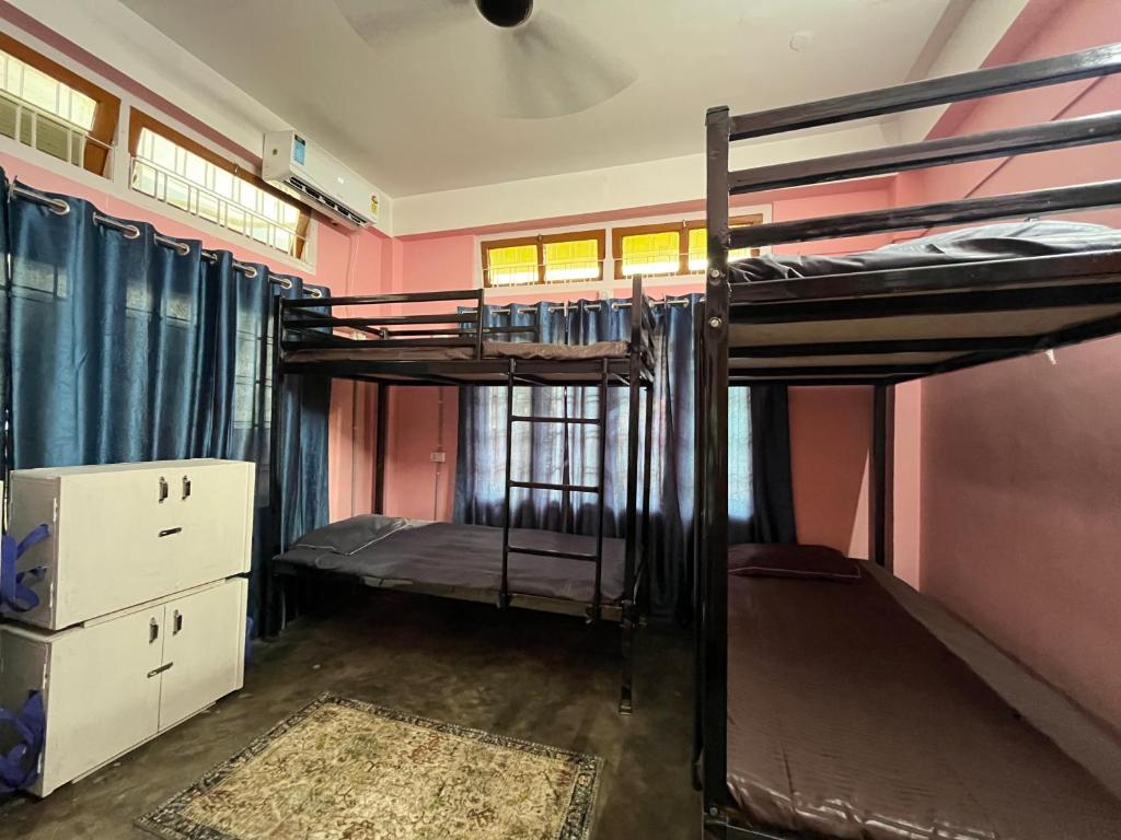 a room with two bunk beds in it at The Backpackers Hostel in Guwahati