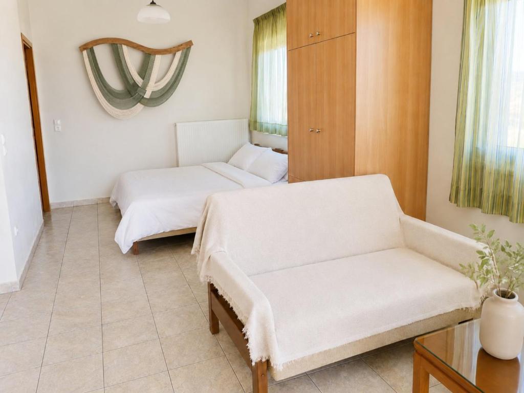 a living room with two beds and a couch at MARGIANNA APARTMENTs Seaside Studio in Káto Ássos