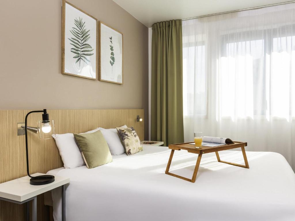 a hotel room with a bed with a table on it at Aparthotel Adagio Access Paris Reuilly in Paris