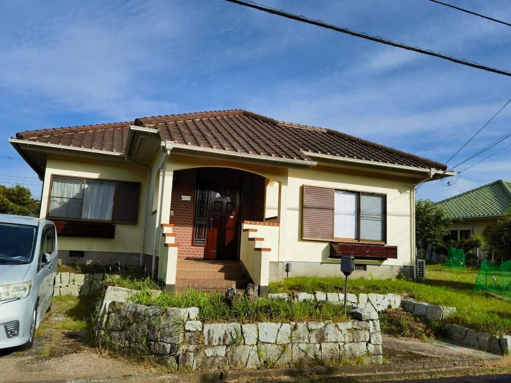 a house with a car parked in front of it at Villa9 in Onjuku