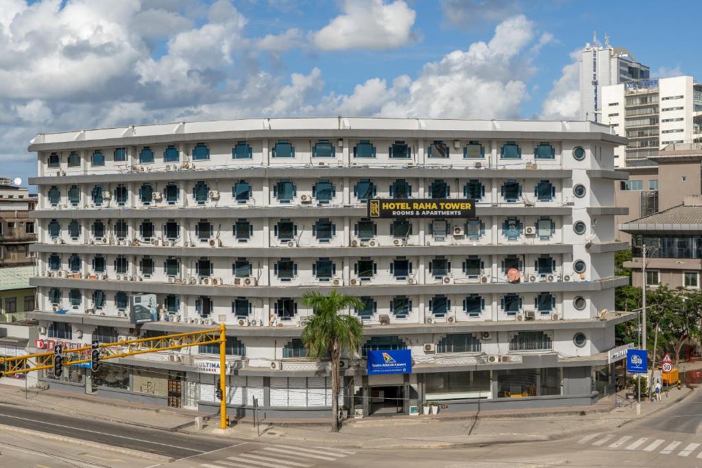 a large white building with a sign on it at Hotel Raha Tower in Dar es Salaam