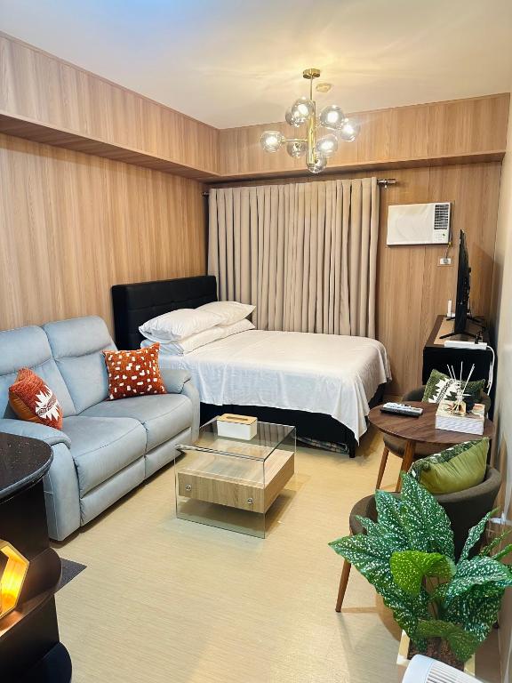 a living room with a bed and a couch at JB's Space in Cagayan de Oro