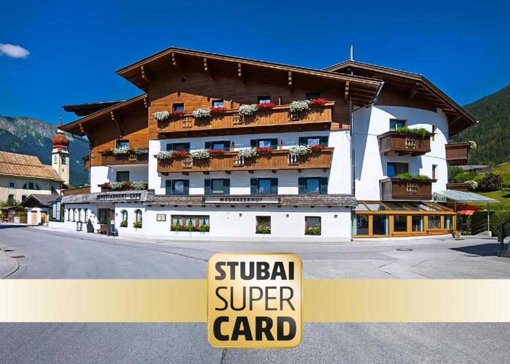 a building with a sign that reads surgical super card at Hotel Medrazerhof in Fulpmes
