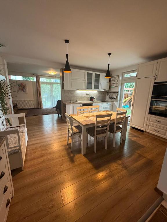 a kitchen and dining room with a table and chairs at Harmony Haven - Spacious 4BR House with Free Parking in Cluj-Napoca