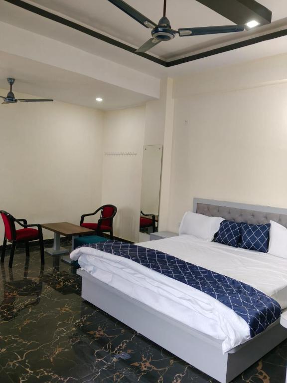 a bedroom with a bed and a table and chairs at NestIN hotels in Lucknow