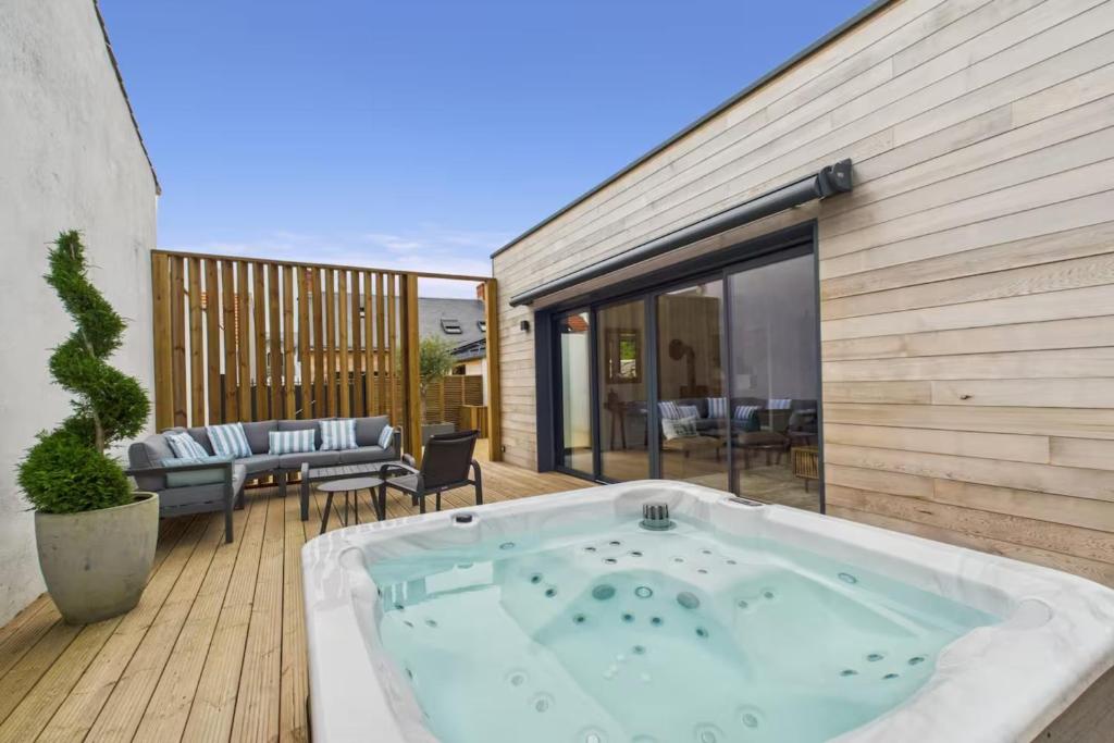 a hot tub on the deck of a house at Villa Boréal with spa in the heart of St Gilles in Saint-Gilles-Croix-de-Vie