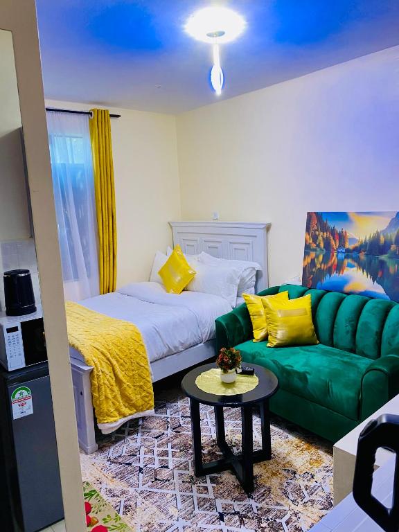a living room with a couch and a green couch at The Crown Stay in Machakos