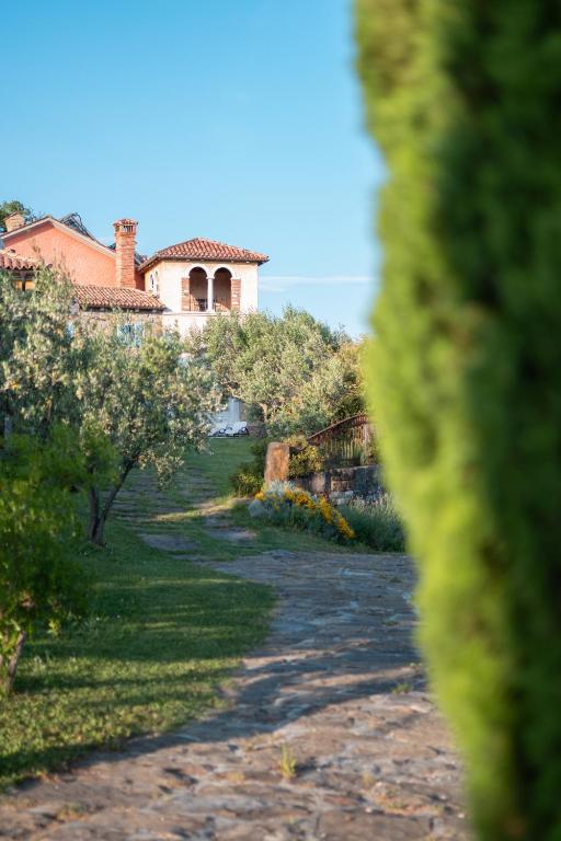 a house on top of a hill with a pathway at Dobrinja Residence - A boutique hideaway in Marezige