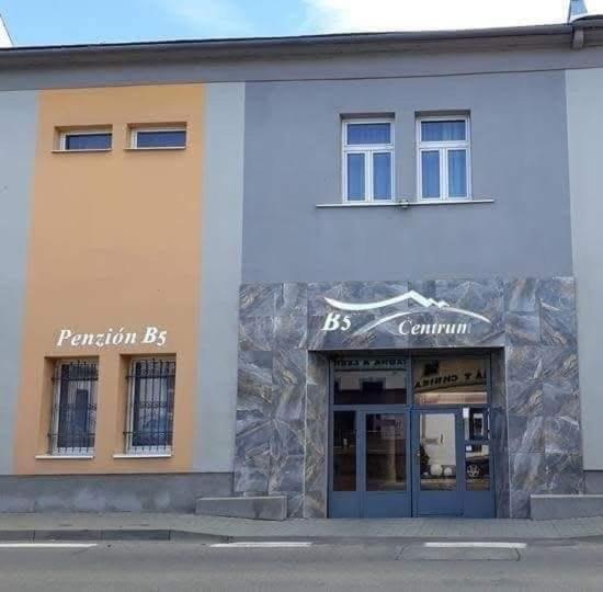 a store front of a building with a blue door at Penzion B5 in Kežmarok