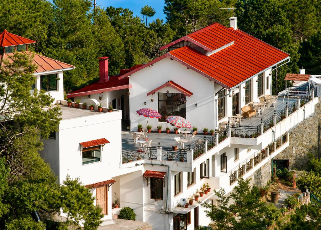 an aerial view of a building with a red roof at Woodsvilla Resort Ranikhet in Rānīkhet