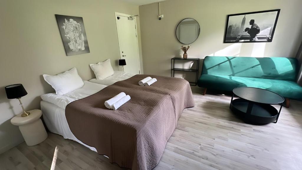 a hotel room with a bed and a couch at Glaskogen Holiday Homes in Glava