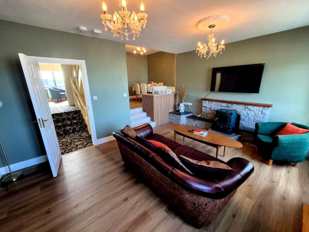 a living room with a couch and a table at Cuchulainn Townhouse in Galway
