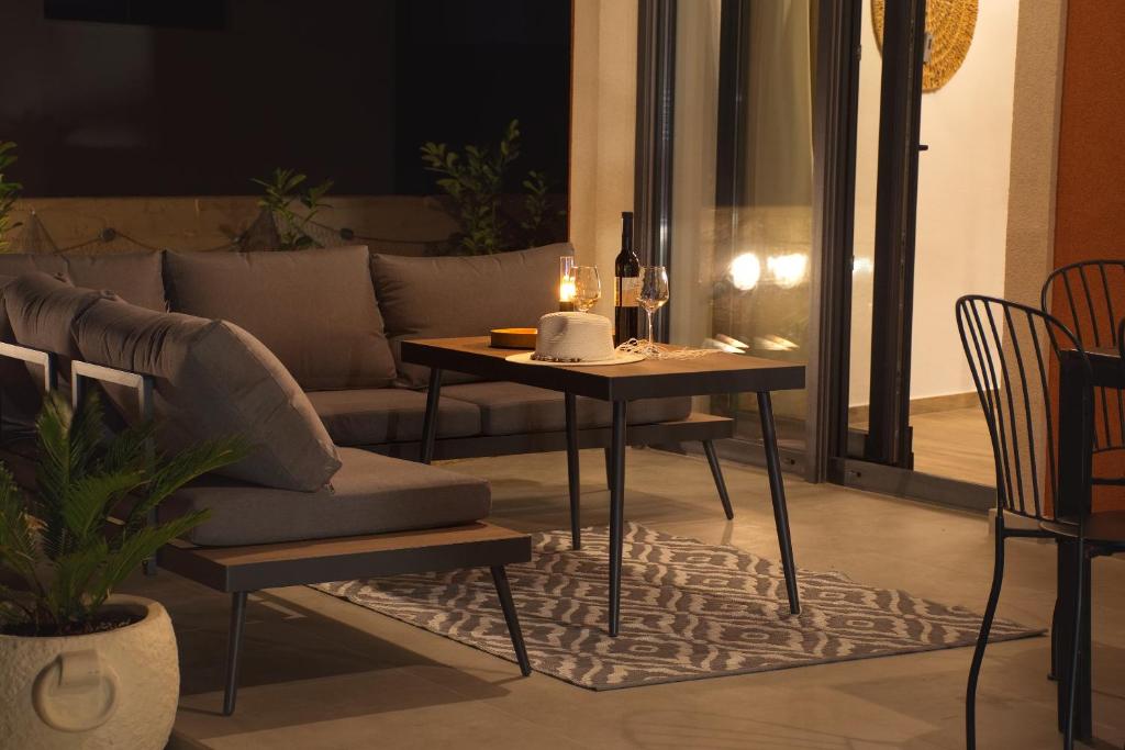a living room with a table and a couch at PaCha Boutique house in Novalja