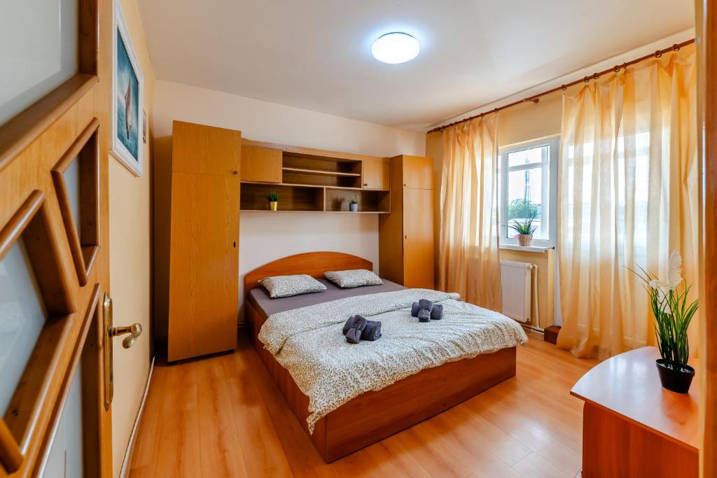 a bedroom with a bed with two stuffed animals on it at Walter Waves Private Apartment with Balcony and Self Check-In in Costinesti