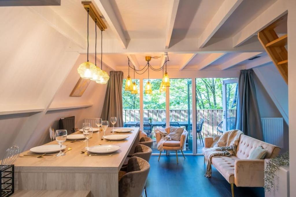 a dining room with a long table and chairs at Chalet Lupin in Durbuy