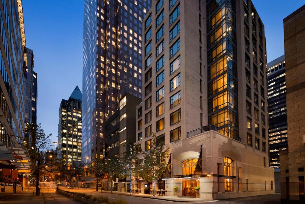 a tall building in a city at night at Hotel Le Soleil by Executive Hotels in Vancouver