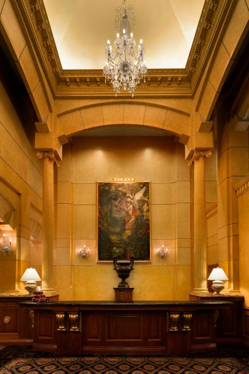 a large room with a chandelier in a building at Hotel Le Soleil by Executive Hotels in Vancouver