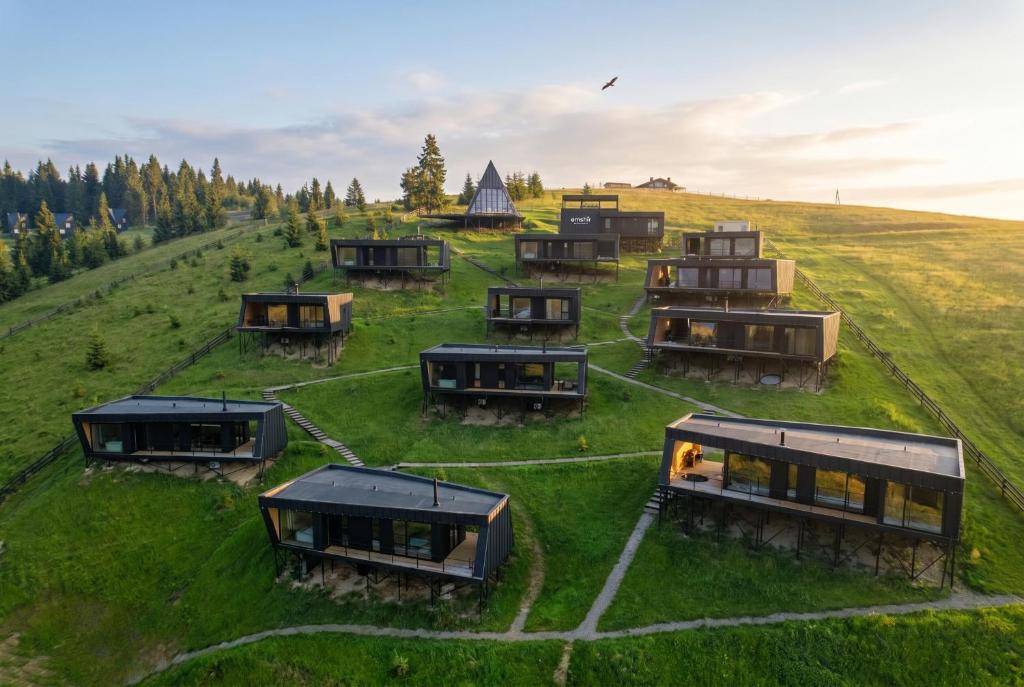 a group of tiny houses on a grassy field at Emshir Villas in Krasnik