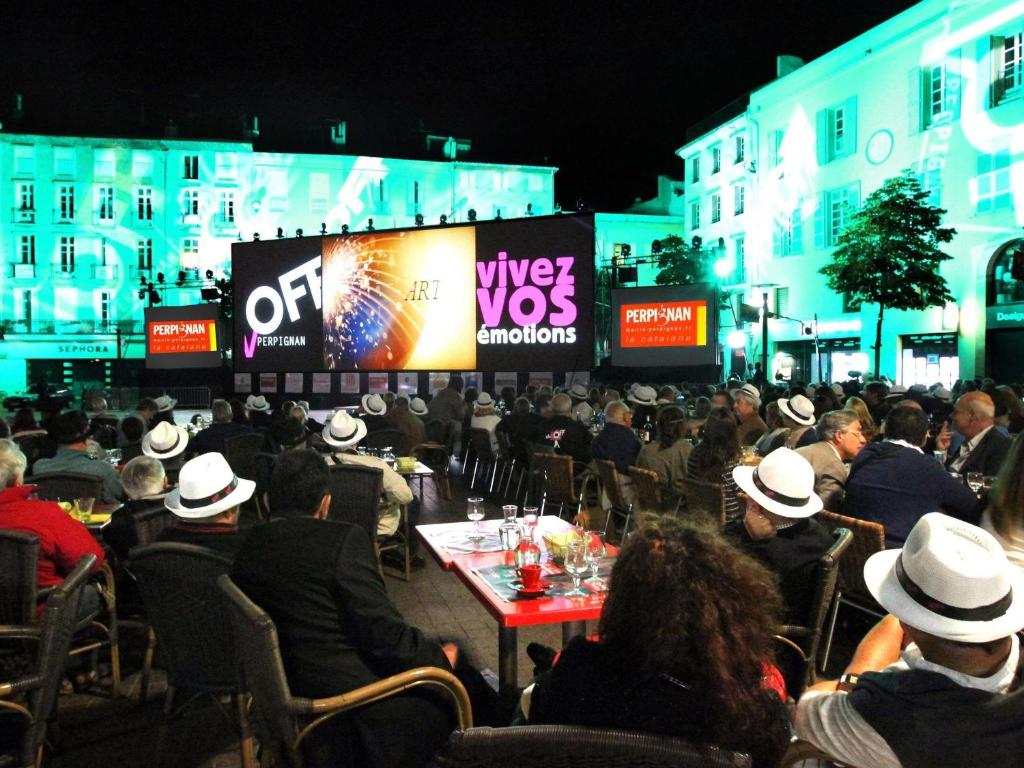 a crowd of people sitting in chairs at an event at HotelF1 Perpignan Sud in Perpignan