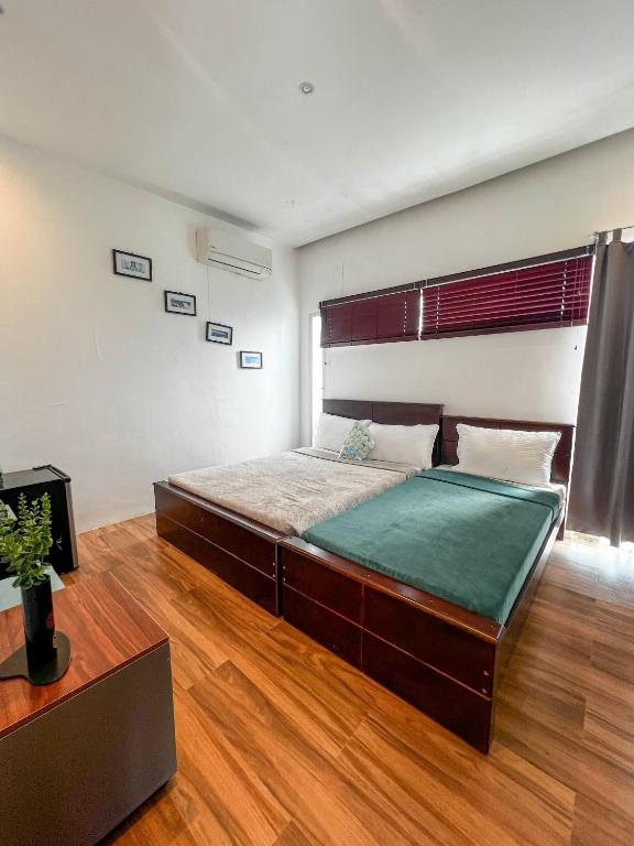 a bedroom with a large bed in a room at The Hermitage Tagaytay-Junior Suite in Malabag