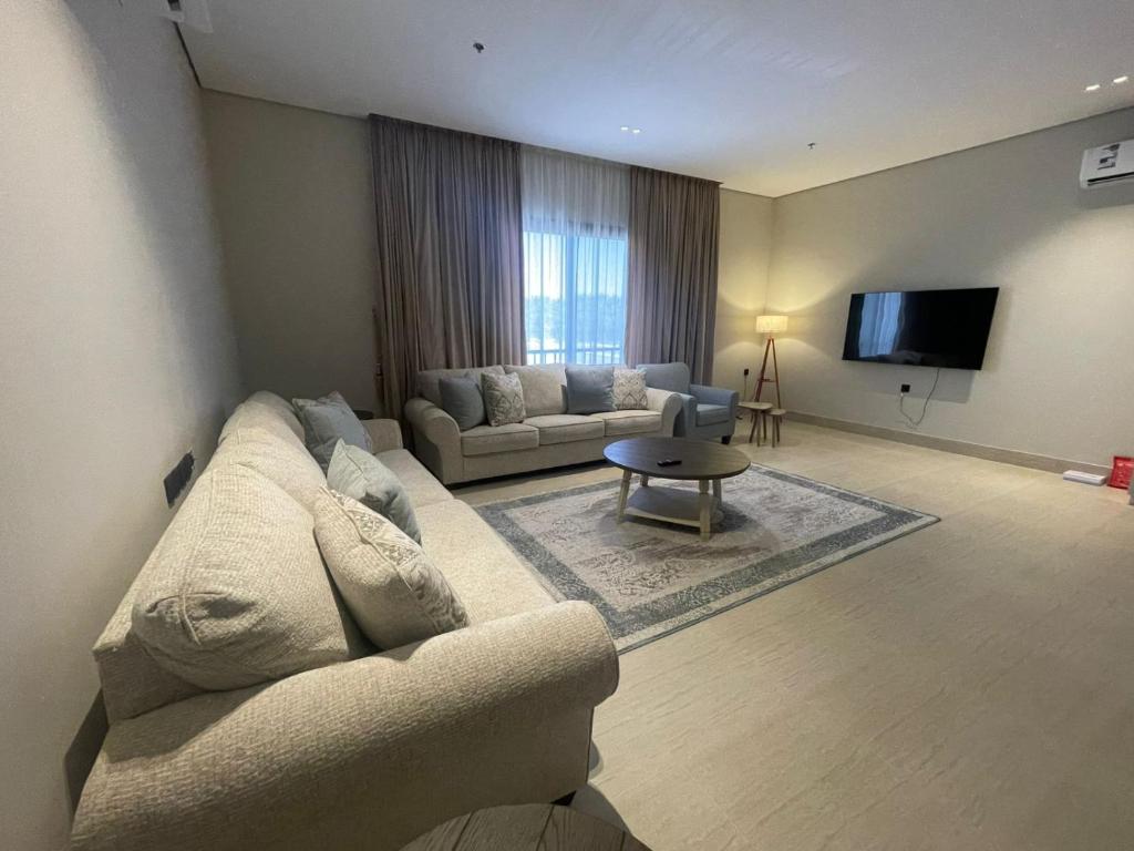 a living room with a couch and a tv at شقة O&Me الفندقية in Medina